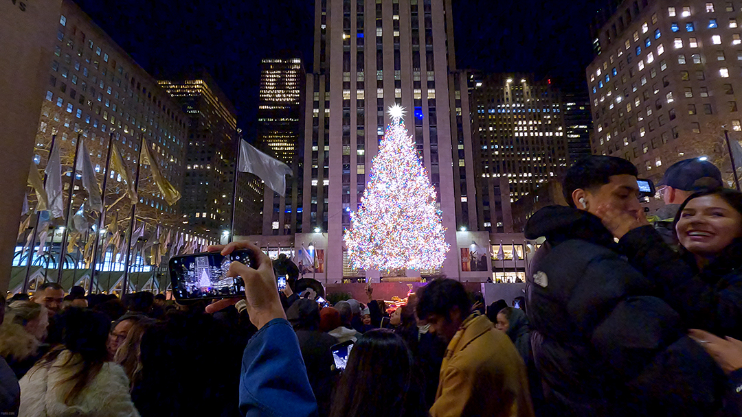 The Rockefeller Center Christmas Tree, lit up at night.